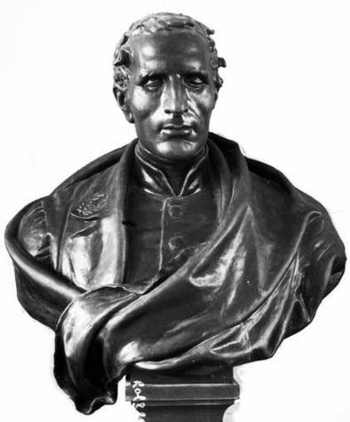 Black-and-white photograph of a bronze bust of Louis Braille, shown with closed eyes and a cloak draped over his shoulders
