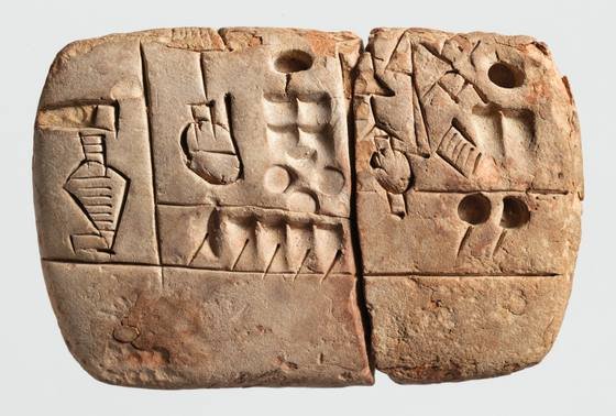 A small clay tablet divided into boxes containing pictographic signs and round number impressions
